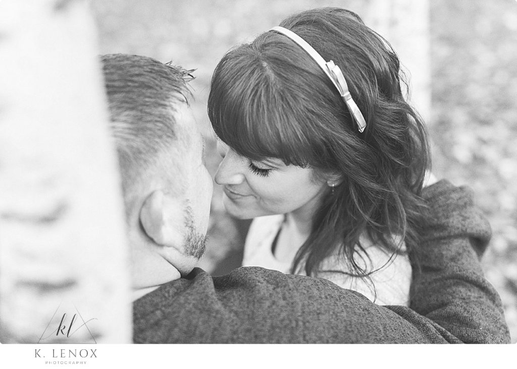 Black and White photo of a man and woman just about to kiss. 