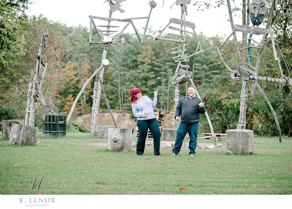 Engaged couple having fun while playing "air Guitar' while at the Path of Life Garden in VT. 