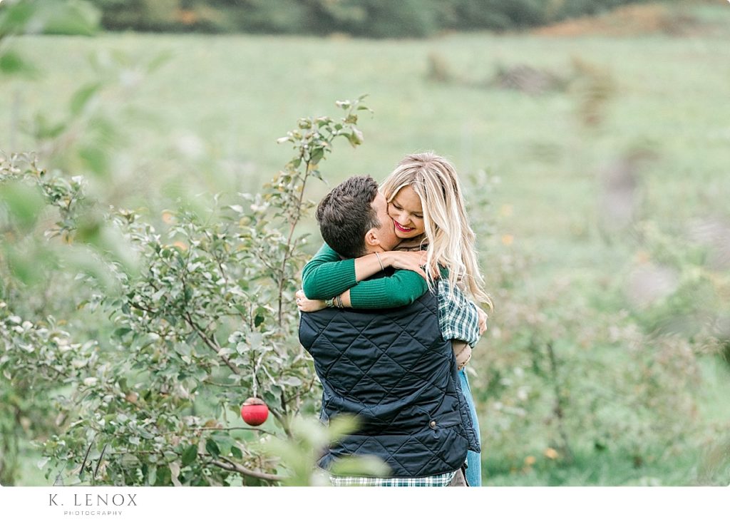 Couple hugging in the Orchard at Scott Farm during their Fall Engagement Session. 