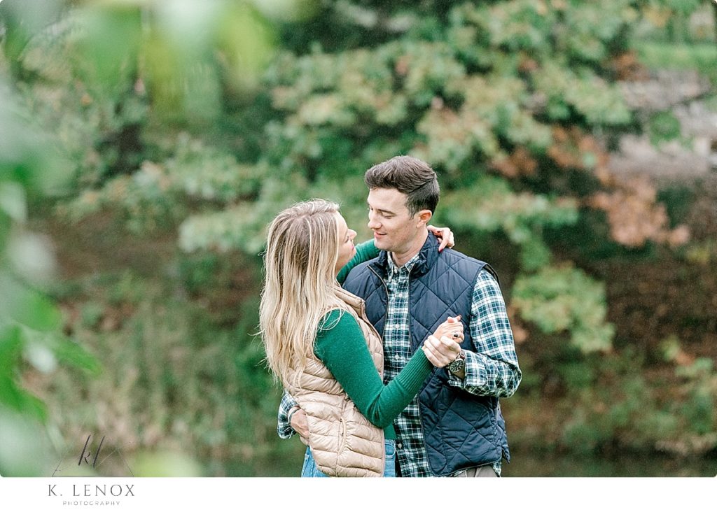 Couple hold each other while talking during their Fall Engagement Session at Scott Farm in Brattleboro Vt. 