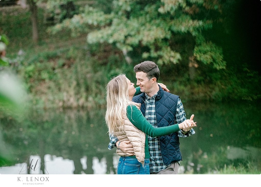 People in love dancing during their fall engagement session with K. Lenox Photography. 