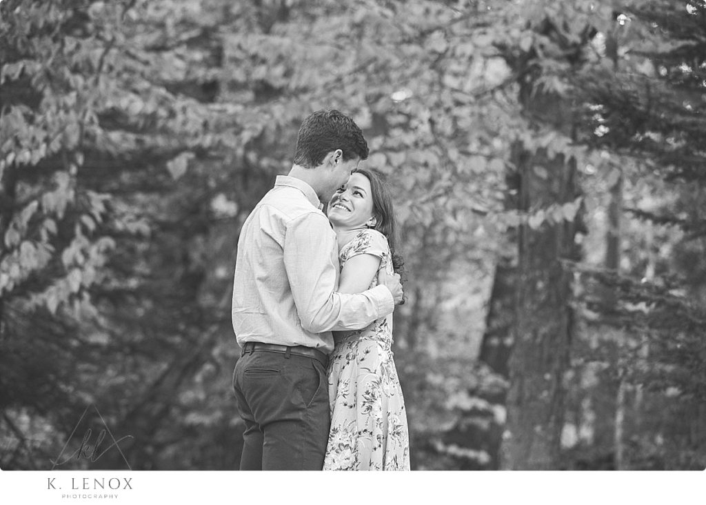 Black and White photo of an engaged couple cuddling on a chilly day. 