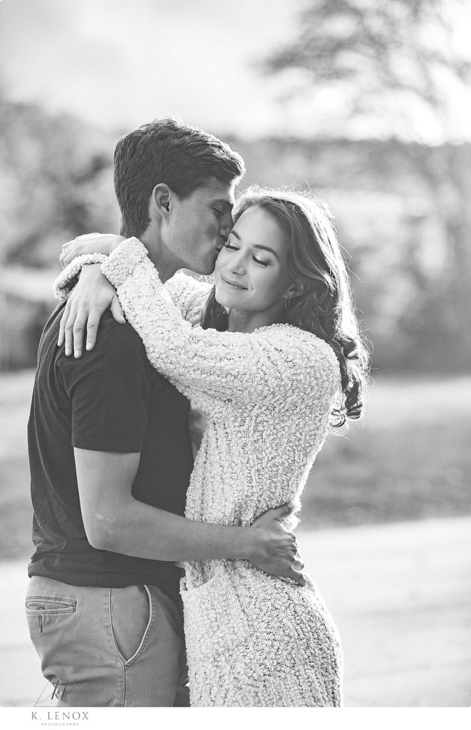 Black and White Photo of an engaged man and woman hugging. 