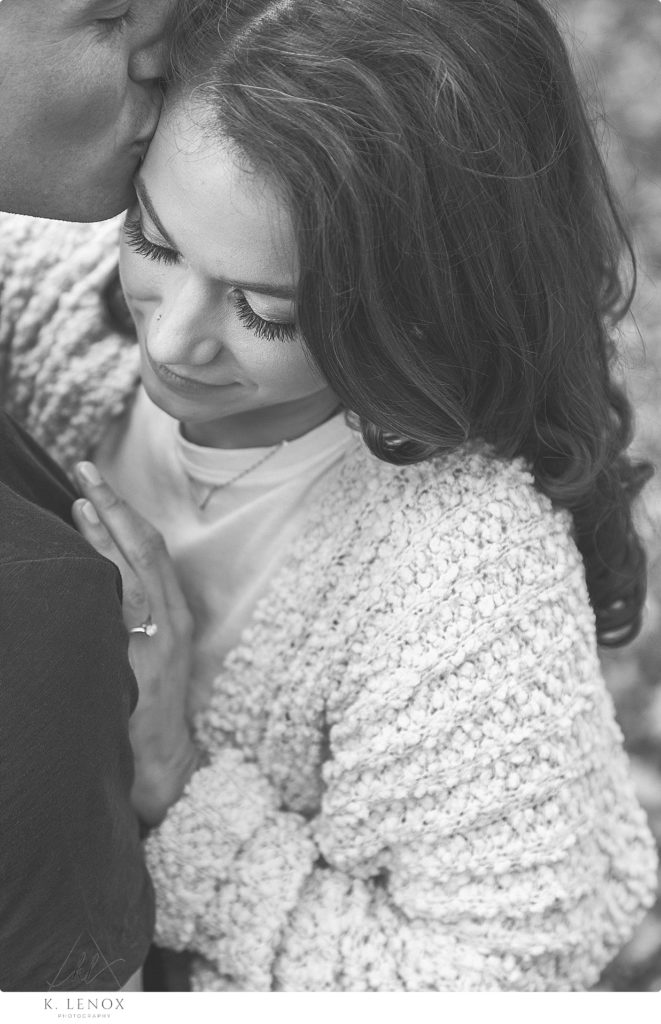 Black and White close up, detail photo of a woman hugging her fiance. 