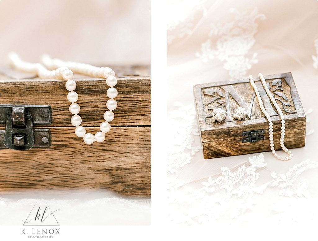 Wooden box photographed with a pearl necklace draping over top. 