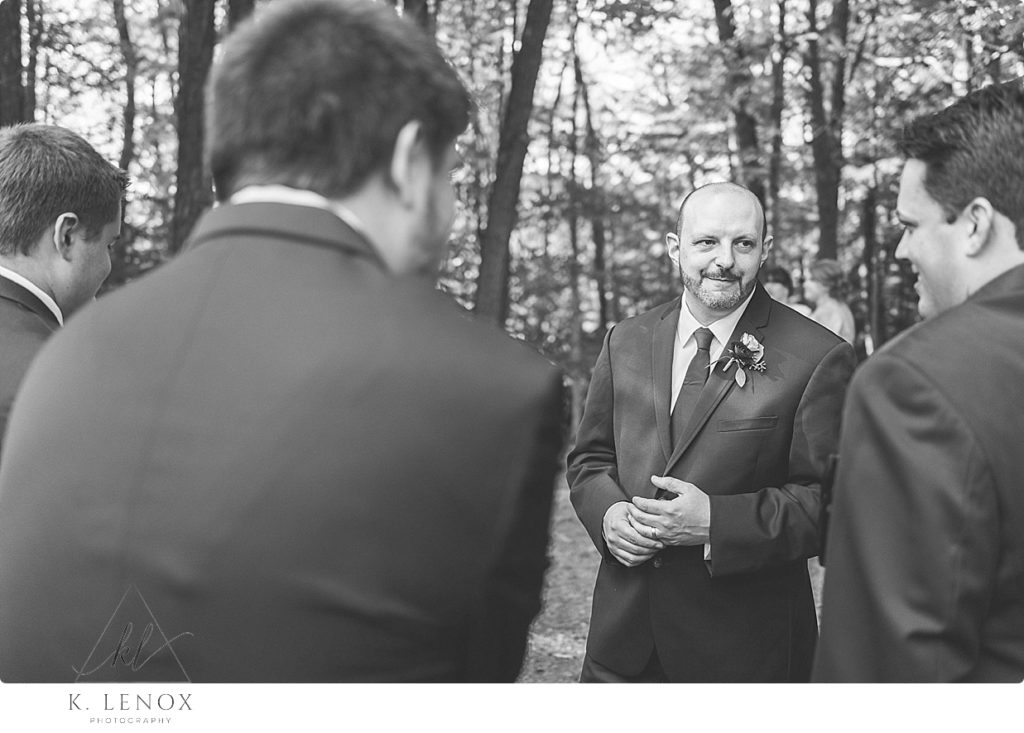 Black and White Candid photo of a Groom talking with this groomsmen