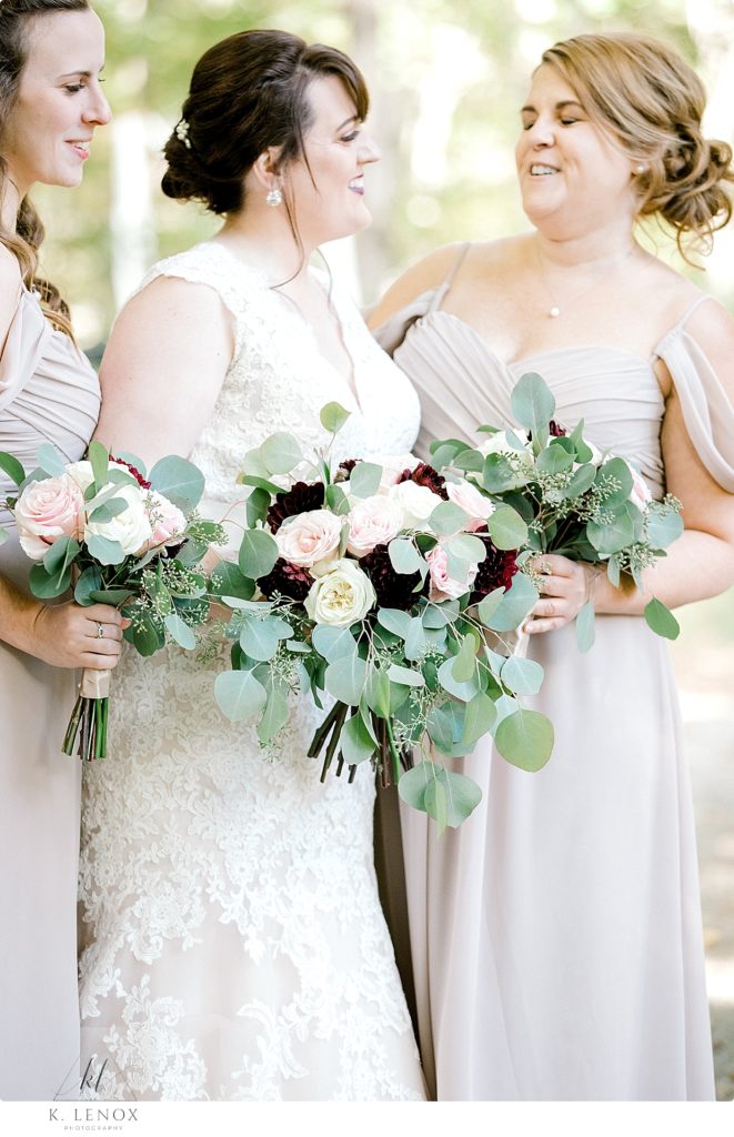 A bride and bridesmaids hold their bouquets. 