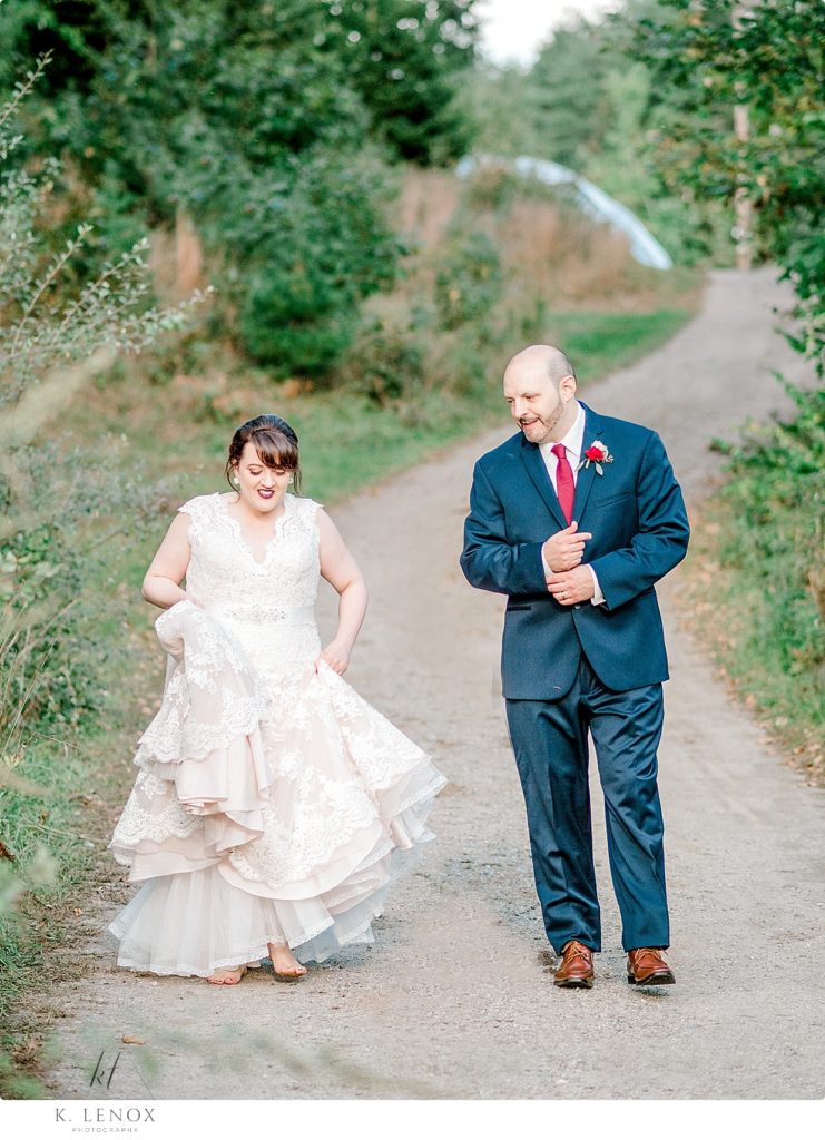 Bride and Groom walk together in a Candid shot at Stonewall Farm. 