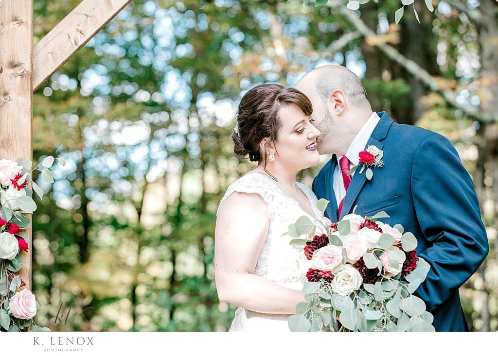 Bride and Groom are nuzzling for a photo at Stonewall farm. 