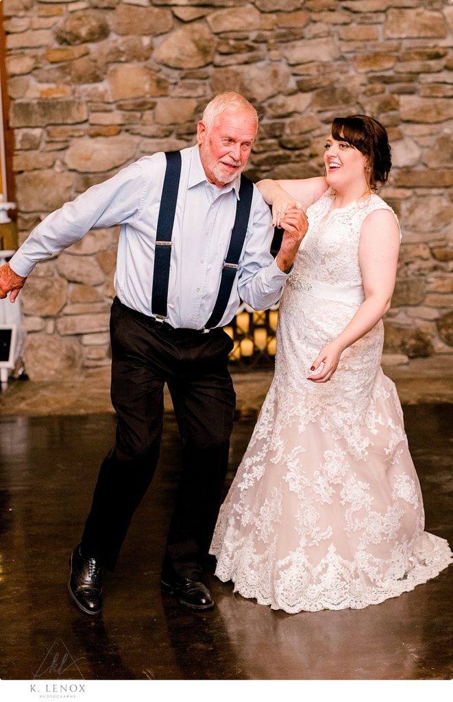 Bride dances with her new father in law at her wedding reception at Stonewall farm. 