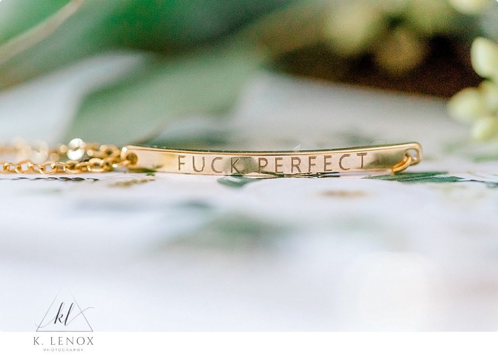 Gold bracelet that says, "Fuck Perfect"