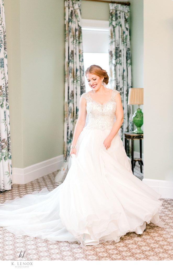 Christmas Wedding Bride spins in her gown while getting ready in the Bridal Suite of the Omni Mount Washington Resort. 