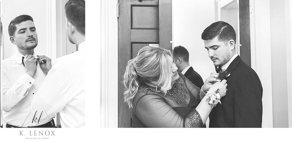 Black and White photo of a Groom getting ready for his wedding. He's putting on his bowtie and his boutonnières 