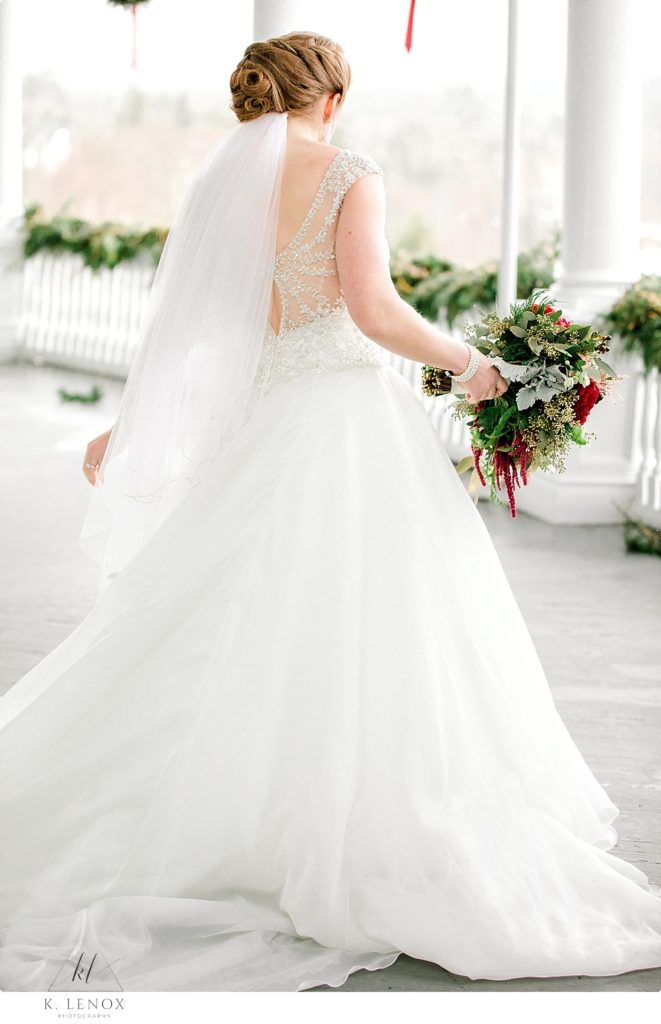 Candid photo of a bride as she walks away from holding her bouquet. 