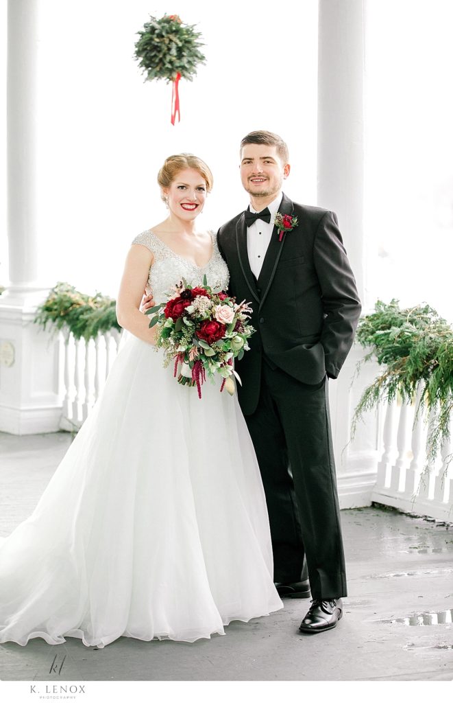 Formal Portrait of a bride wearing a beaded wedding gown, and a groom wearing a tux. Image taken at the Omni Mount Washington Resort. 