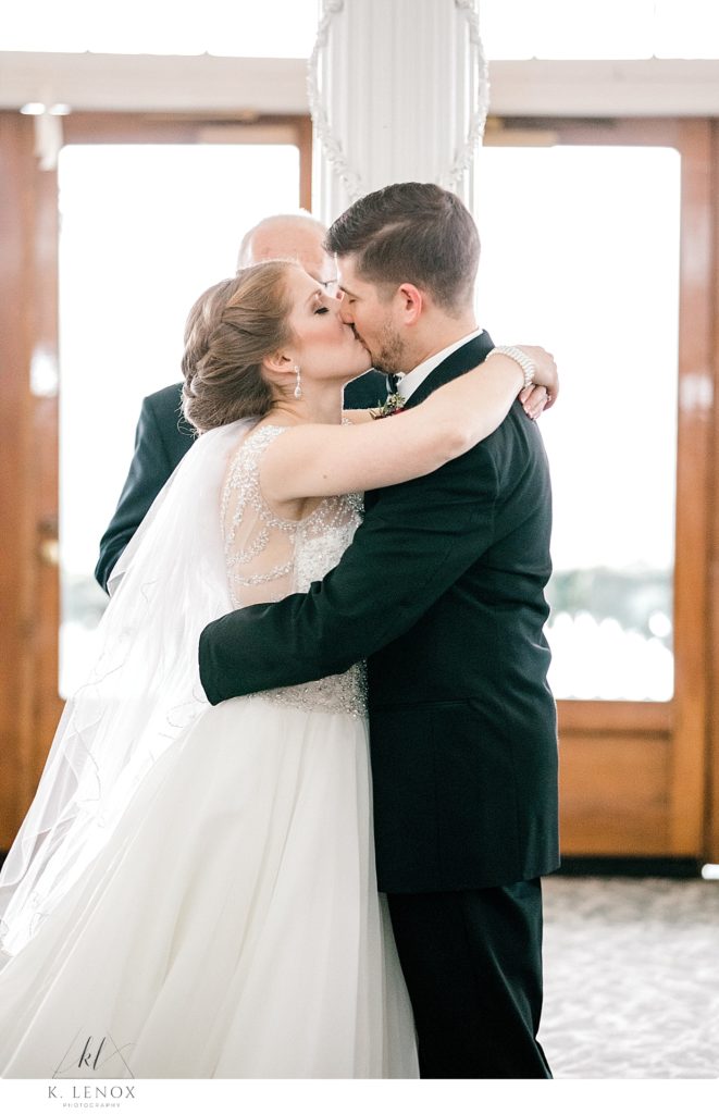 Bride and Groom kiss at the end of their Christmas Wedding Ceremony