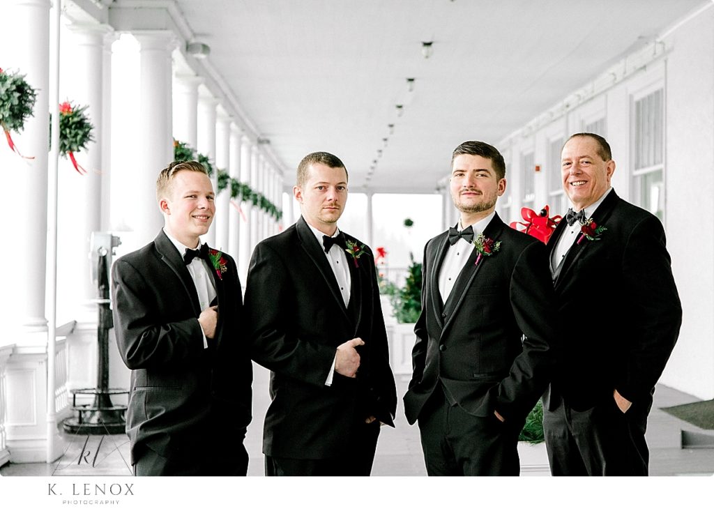 4 men wearing tuxedos pose for a formal portrait at the Omni Mount Washington Resort. 