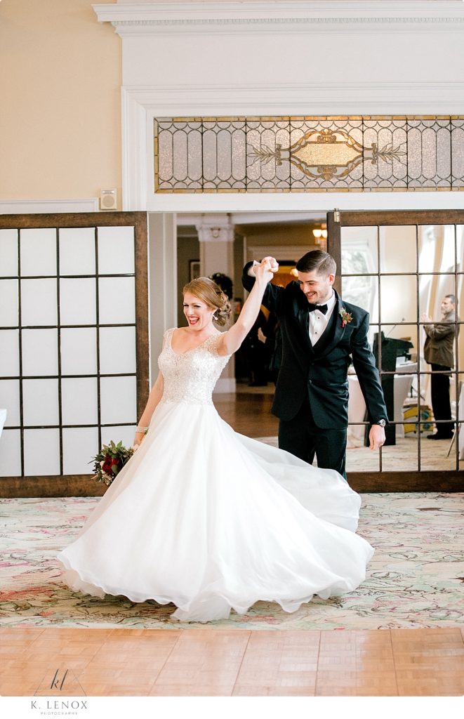 Groom Twirls his wife during their first dance in the Sun Dining room at the Omni Mount Washington Resort. 