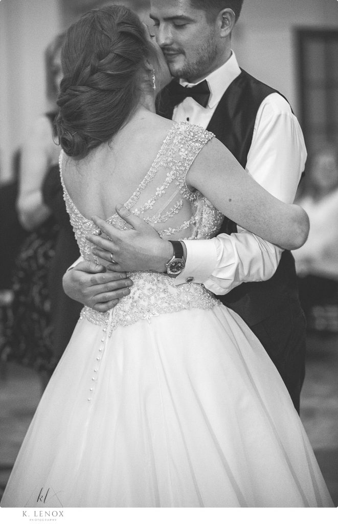 Black and White photo of a bride and groom dancing. 