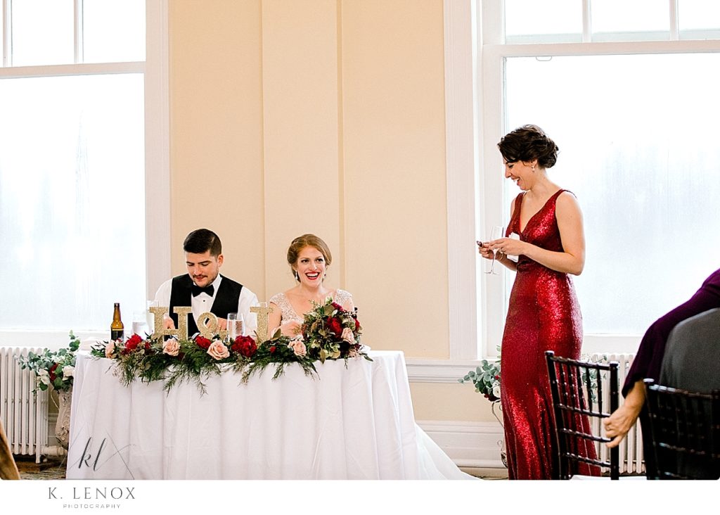 Maid of honor gives a toast during a Christmas Wedding Reception in the Sun dining room of the Omni Mount Washington Resort. 
