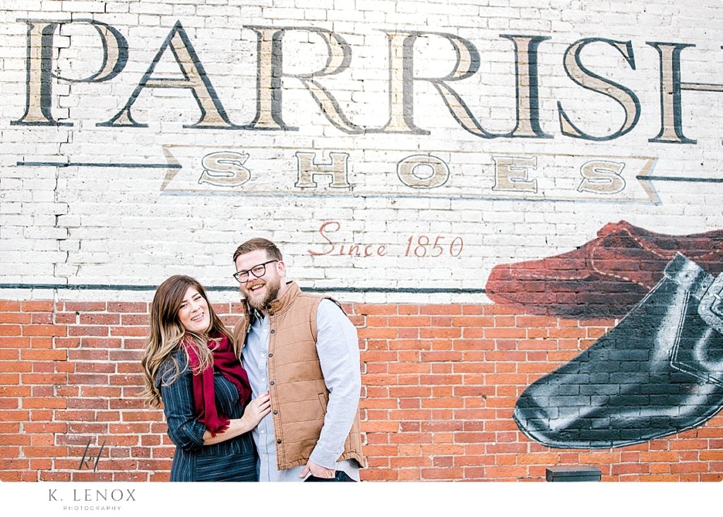 Light and Airy Winter Engagement Session photo in front of the Parrish Shoes sign in Keene NH. 
