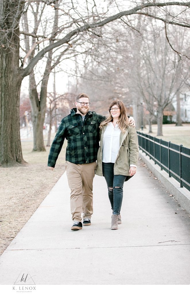 Candid and laid back photo of a man and woman walking on a sidewalk. Light and Airy engagement session w/ K. Lenox photography. 