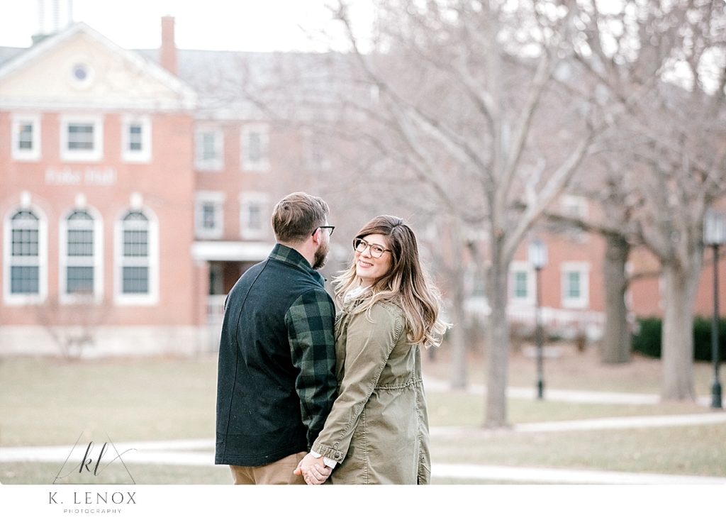 Man and Woman holding hands for a Light and Airy Winter engagement photo. 