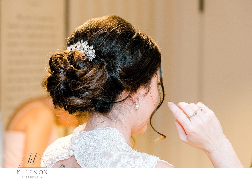 Bridal Hair- pulled back in a messy updo bun. 