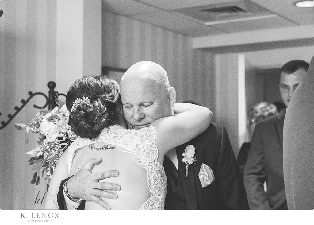 Black and White candid photo of a dad hugging his daughter on her wedding day at the Barn at Gibbet Hill in Groton Ma