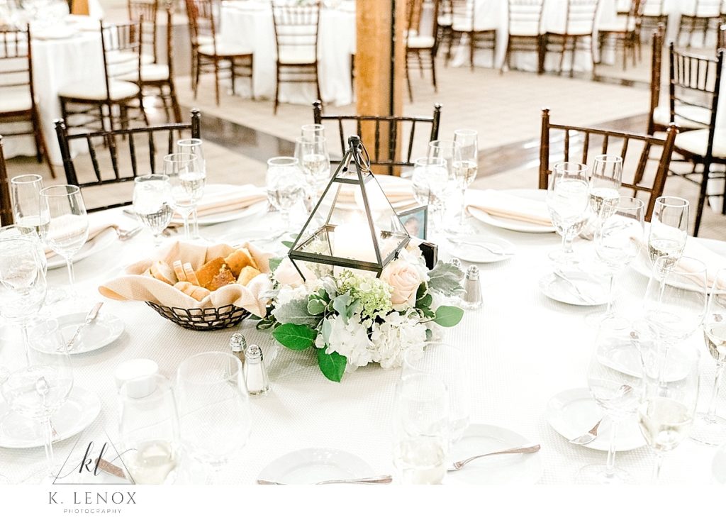 Wedding reception table decor showing light and airy candle centerpiece. Taken by K. Lenox Photography