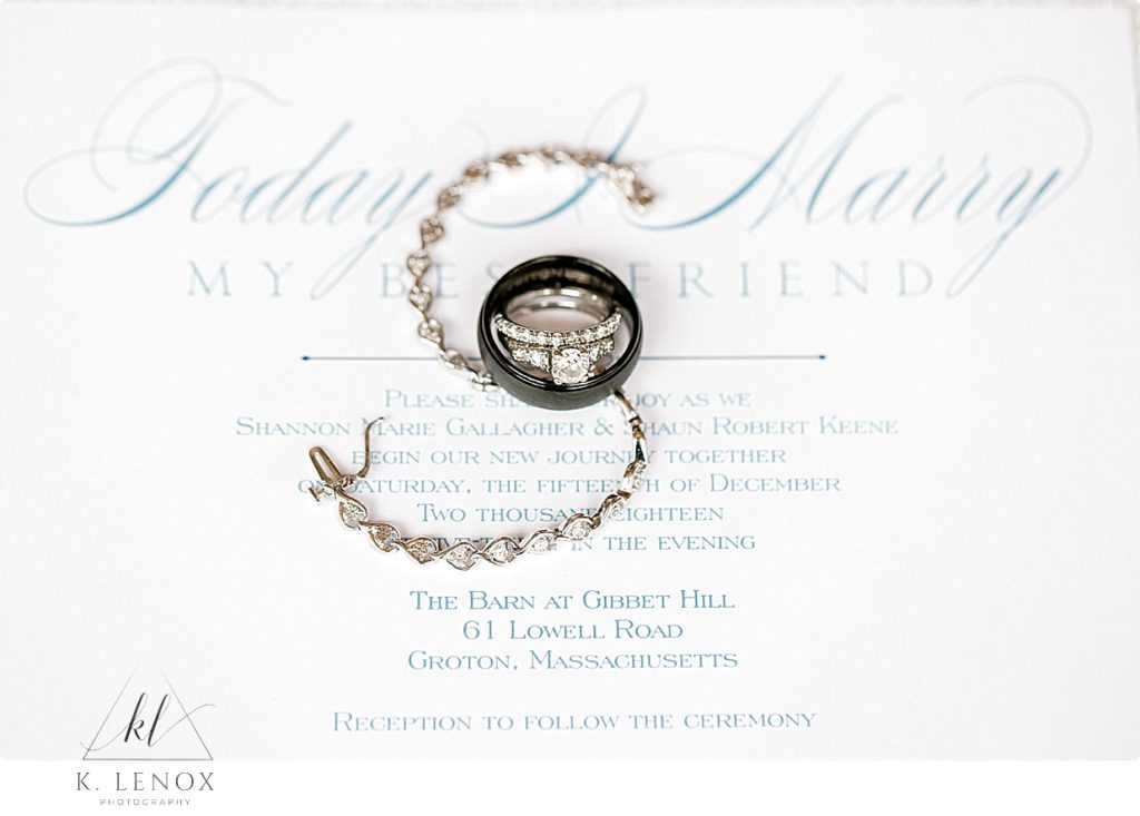 White Gold and Diamond wedding ring set shown with a white gold diamond tennis bracelet on a white invitation with blue font. 