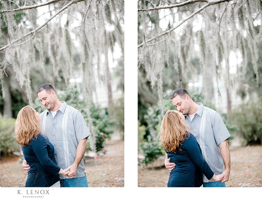 Light and Airy Engagement photo of a man and woman at Kate Gleason Park in SC. Photo by K. Lenox Photography. Spanish Moss hanging from the trees. 