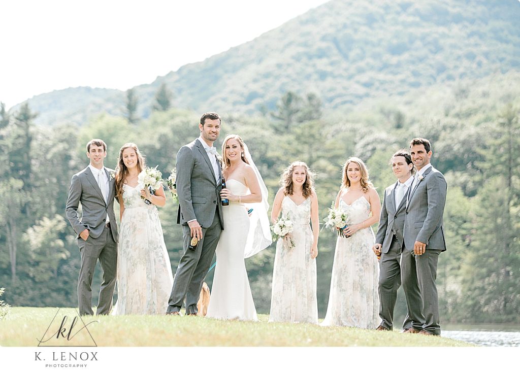 How to Prioritize Comfort on Your Wedding Day- Bridal Party walking together on a nice day next to a  pond.