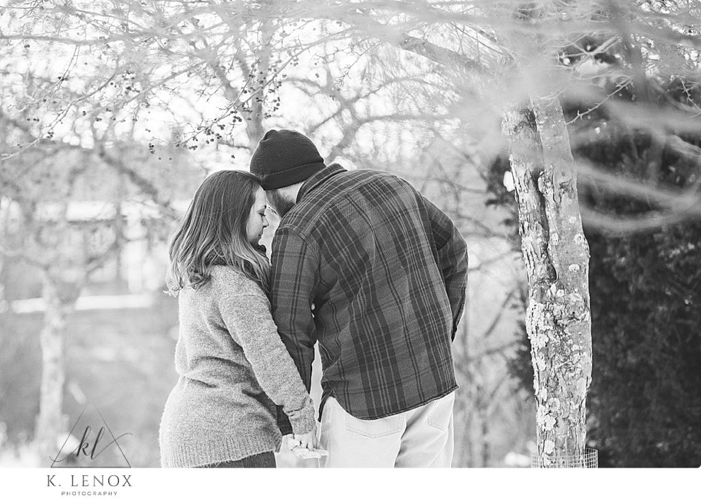 Emotional and candid photo during a winter engagement session in Peterborough nh