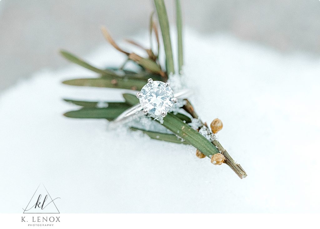 White gold diamond engagement ring.  Solitaire diamond ring in the snow.  
