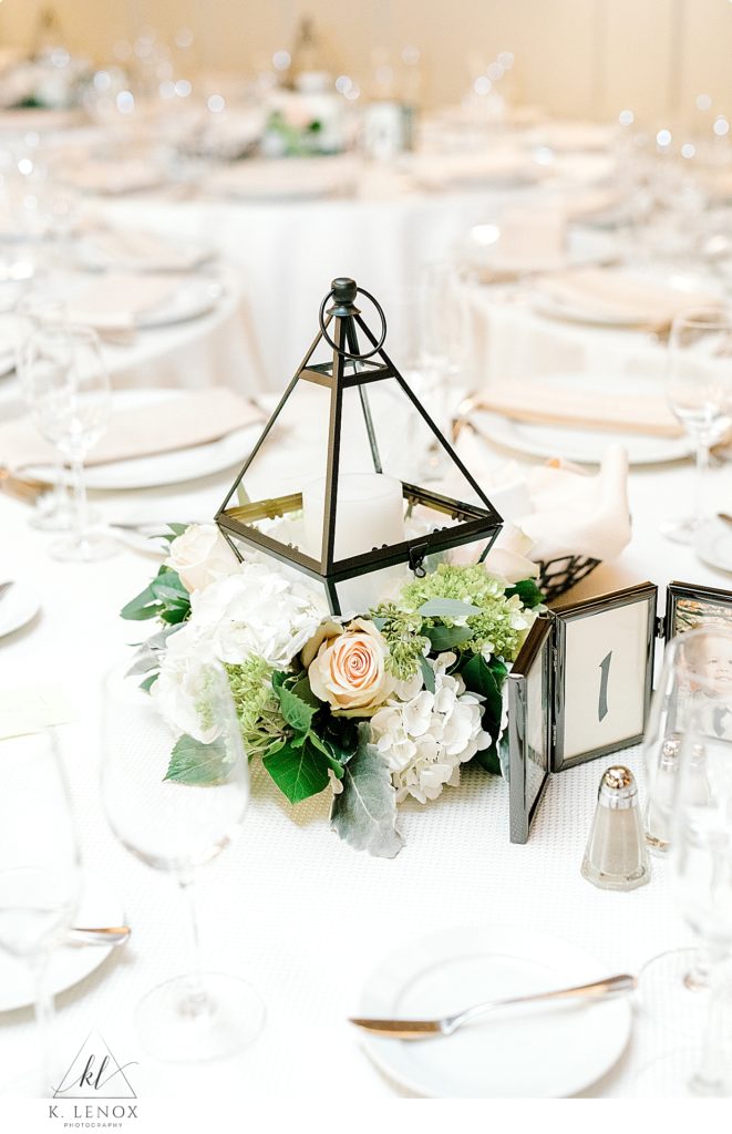 A floral and triangular lantern centerpiece for a winter wedding. 
