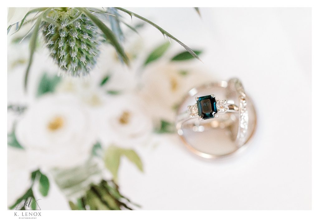 White Gold Engagement ring with a Sapphire stone surrounded by two diamonds.  Light and Airy wedding photo.  