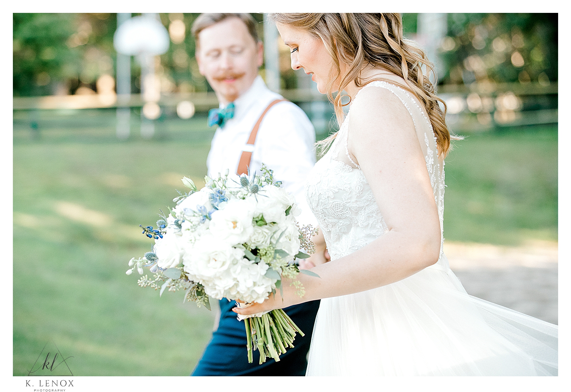 Candid photo of a bride and groom walking. Light and airy photography by K. Lenox Photography