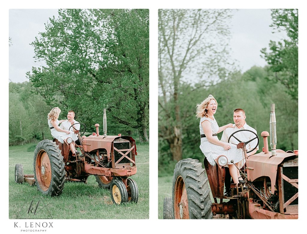 Guy gives the camera a finger to be silly and his fiance laughs.  They are sitting on a tractor for their engagement session in PA. 
