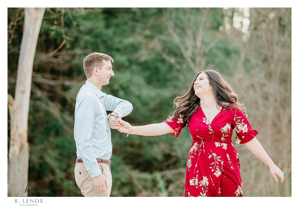Light and Airy photo of a man and woman dancing and flirting during their engagement Session in NH. 