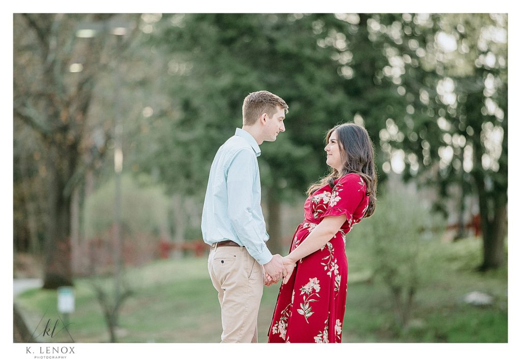 Engagement Session in Peterborough NH- man and woman hold hands and looking at each other. 