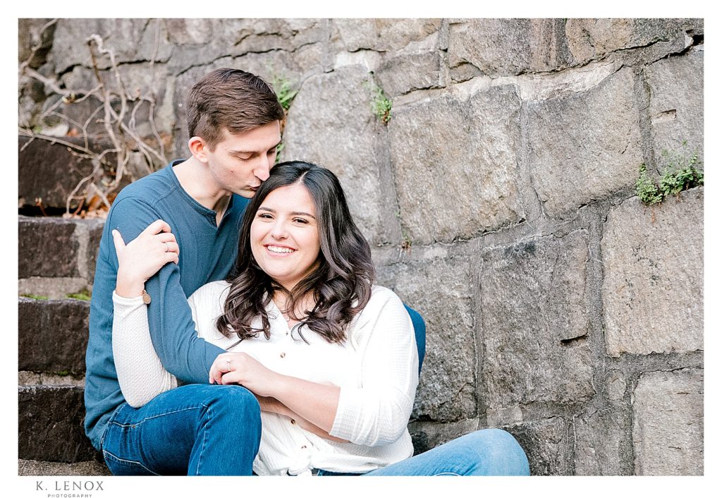 Photograph taken of a man and woman sitting on Stone Stairs in Peterborough NH.   Engagement Session with couple wearing jeans