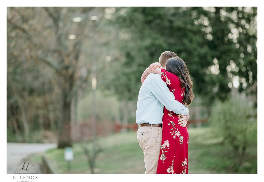 Man and woman genuinely hugging during a tender moment at their Spring Engagement Session with K. Lenox Photography
