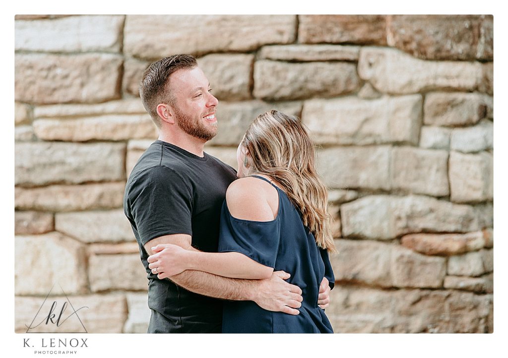 Candid engagement photo of a man and woman laughing together during their Relaxed Engagement session in Brattleboro VT