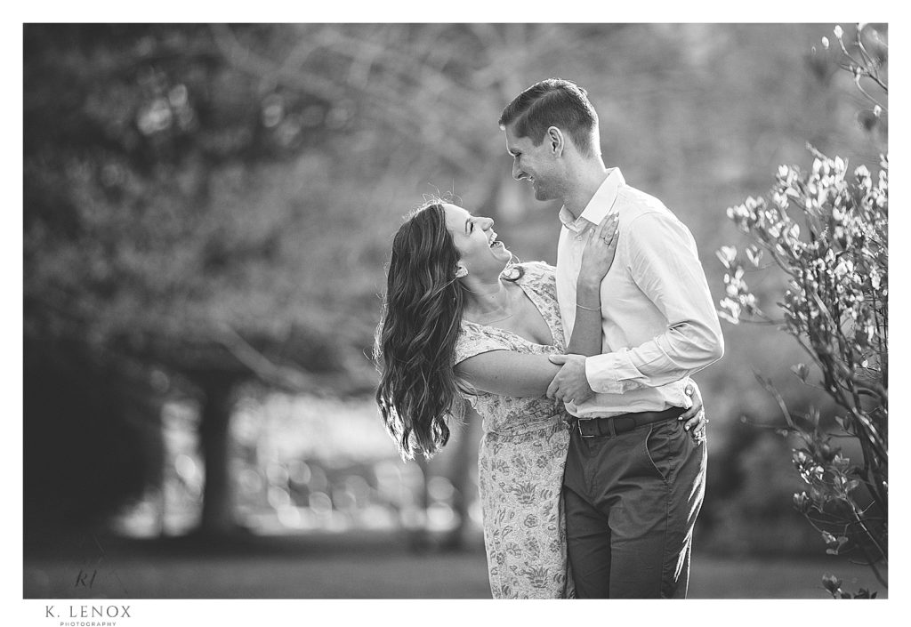 Candid and playful black and white photo of a couple in boston during their engagement session. 