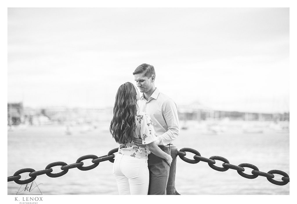 Black and White Candid photo of a man and woman during their spring engagement session in Boston. 