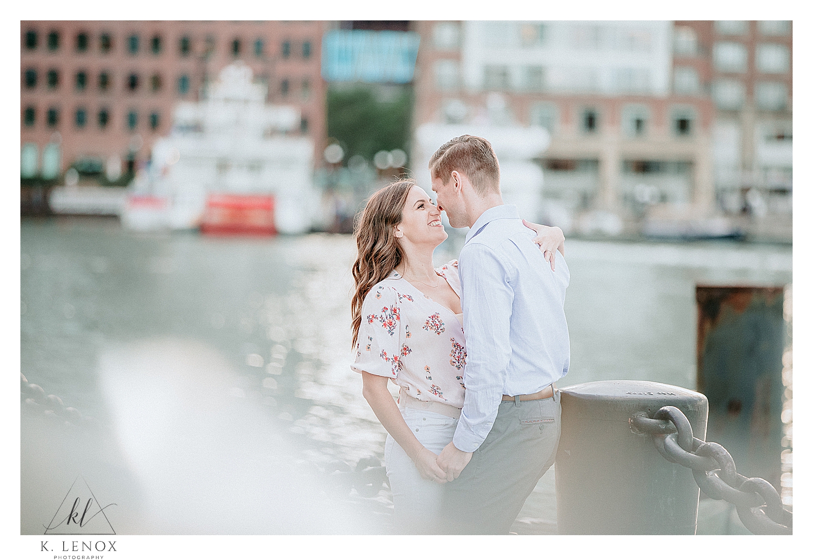 Engaged couple have a candid portrait taken at the Seaport in Boston during their Spring Engagement Session.