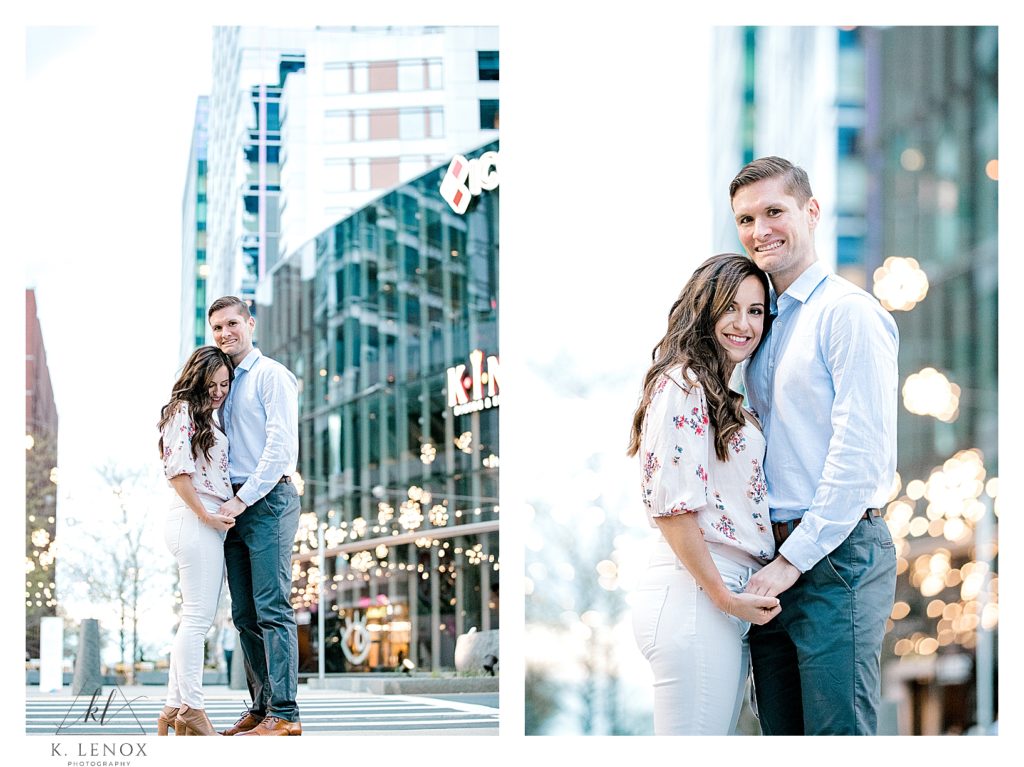 Man and Woman pose for a portrait in Boston during their Spring Engagement Session.  Woman Wearing White skinny capris.  