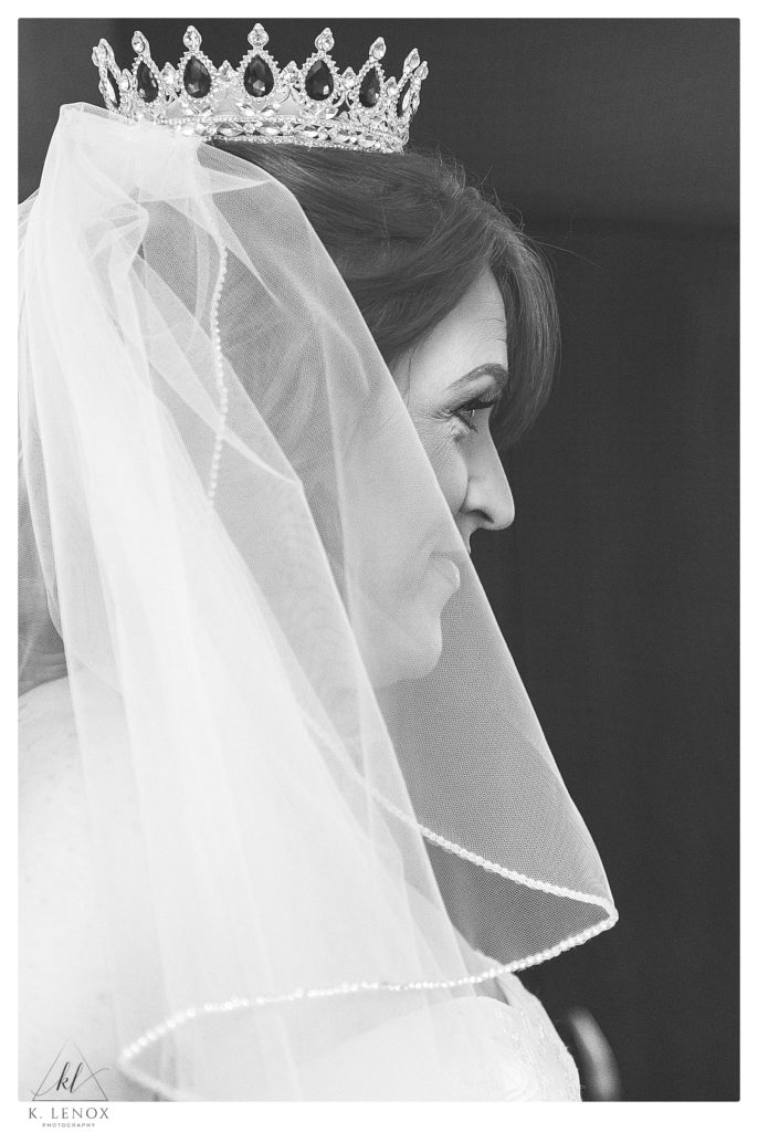 Black and White profile image of a bride wearing a crown and her veil on her wedding day with a Game of throne theme. 