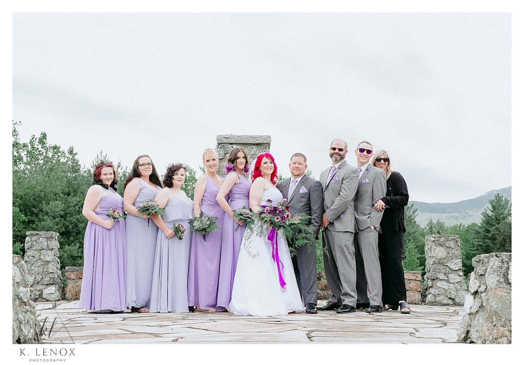 Entire Wedding Party sit upon a Stone Terrace for a formal portrait of Enchanted Forest Wedding with a Game of Thrones Twist